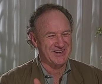 Alt: Młody Gene Hackman w dynamicznej scenie filmowej, oddającej intensywność jego ról akcji.