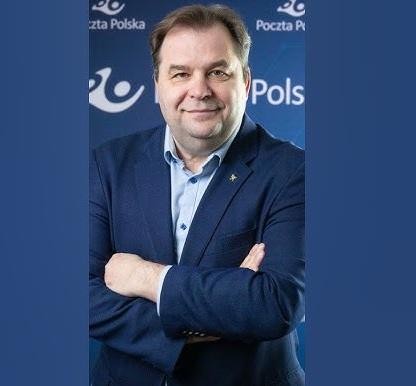 Sebastian Mikosz w dynamicznej pozie na tle subtelnych elementów związanych z Pocztą Polską, symbolizujący jego rolę w transformacji spółki.